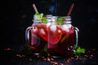 Frozen red tea with lime, ice and mint in glass jars, dark background, selective focus