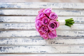 Wall Mural - Beautiful pink bridal bouquet lying on white bench