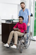 © Tyler Olson - Patient Sitting In Wheelchair While Nurse Standing At Hospital