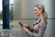 © ottochka - Beautiful businesswoman uses a digital tablet