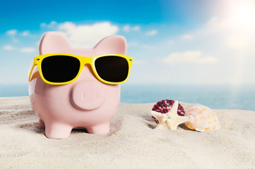 Piggy bank on vacation. Concept of holidays economy