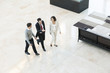© PhotoAlto - Business people walking together in office lobby
