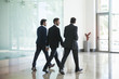 © PhotoAlto - Business people walking together in office corridor