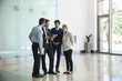 © PhotoAlto - Business people discussing with each other in office corridor