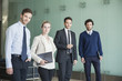 © PhotoAlto - Portrait of business people standing in the office corridor