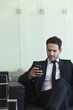 © PhotoAlto - Young businessman using smartphone in the office