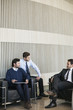 © PhotoAlto - Businessmen discussing in office