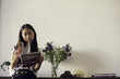© PhotoAlto - Young woman reading magazine