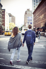 Couple Crossing City Street Together, Rear View