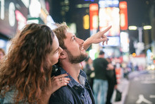 Young Couple Sightseeing In Times Square, New York City, New York, USA