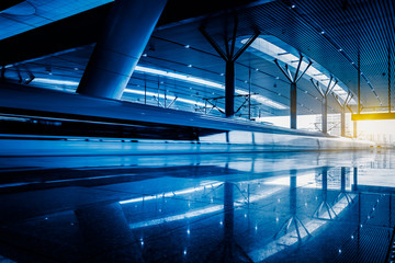 Blurred view of train leaving platform in city of China.