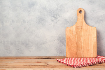 Wall Mural - Kitchen background with cutting board and empty wooden table