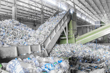 closeup escalator with a pile of plastic bottles at the factory for processing and recycling. pet re