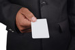 © flowgics - Business man holding card in black suit isolated on white background