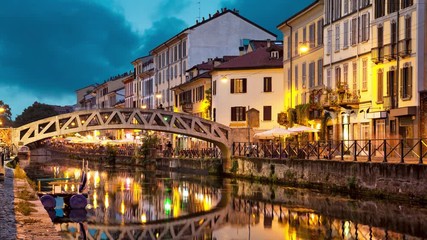 Fototapete - Bridge across the Naviglio Grande canal at the evening in Milan, Italy (static image with animated sky and water)

