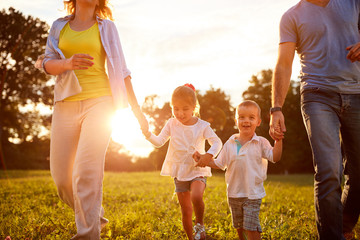 Wall Mural - Young children walking with parents in park