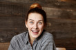 © wayhome.studio  - Headshot of attractive young redhead female with hair bun sitting at cafe, having surprised or stunned facial expression, shocked with some astonishing news, looking at camera with mouth wide open