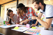 © opolja - group of young business people , Startup entrepreneurs working on their venture in coworking space.