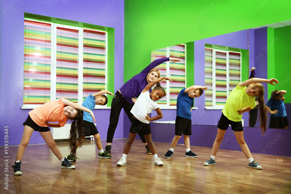 Dance teacher and children in choreography class