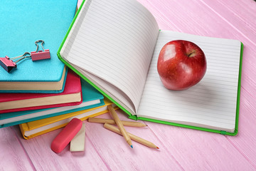 Sticker - Notebooks and apple on wooden background