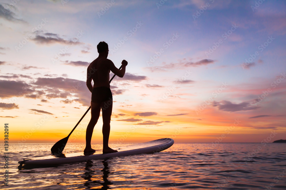 paddleboard on the beach at sunset, paddle standing in Thailand - obrazy, fototapety, plakaty 