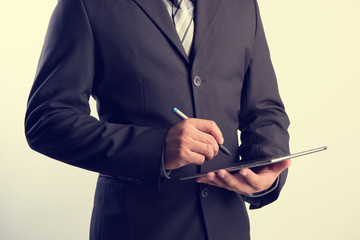 Leinwandbilder - Business man working with a digital tablet in vintage tone style