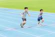 © TinPong - Young Asian boy running on blue track in the stadium