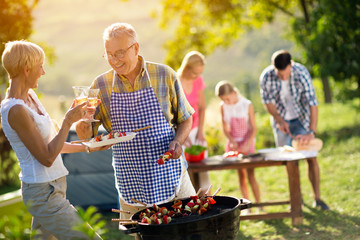 Wall Mural - Happy family having a barbecue party.