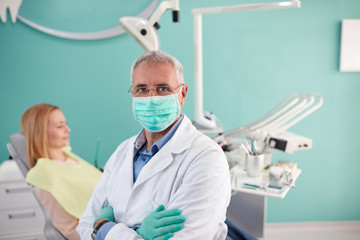 Portrait of senior dentist in dental clinic