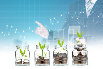 Double exposure of success businessman with coins and seed in clear bottle,Business investment growth concept,saving concept on city landscape background.Forex graph