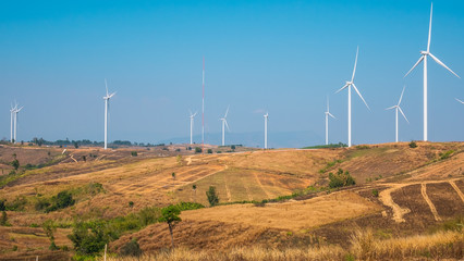 Wind turbine for electricity production on the mountains and beautiful sky.