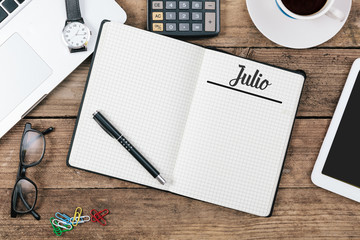 Wall Mural - Julio (Spanish July) month name on paper note pad at office desk