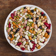 Mix of colorful beans and lentils in bowl. Top view.