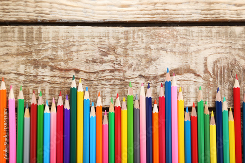 Naklejka - mata magnetyczna na lodówkę Drawing colourful pencils on brown wooden table