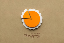 Happy Thanksgiving Day / Creative Thanksgiving Day Concept Photo Of A Pumpkin Pie Made Of Paper On Brown Background.