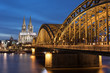 Illuminated Cologne Cathedral and Hohenzollern Bridge At Sunset / Germany