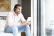 © sepy - Enjoy music. Young African American man listening music on digital tablet