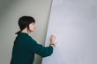 © bodnarphoto - The young woman wipes inscriptions with white marker board. The situation in the office.