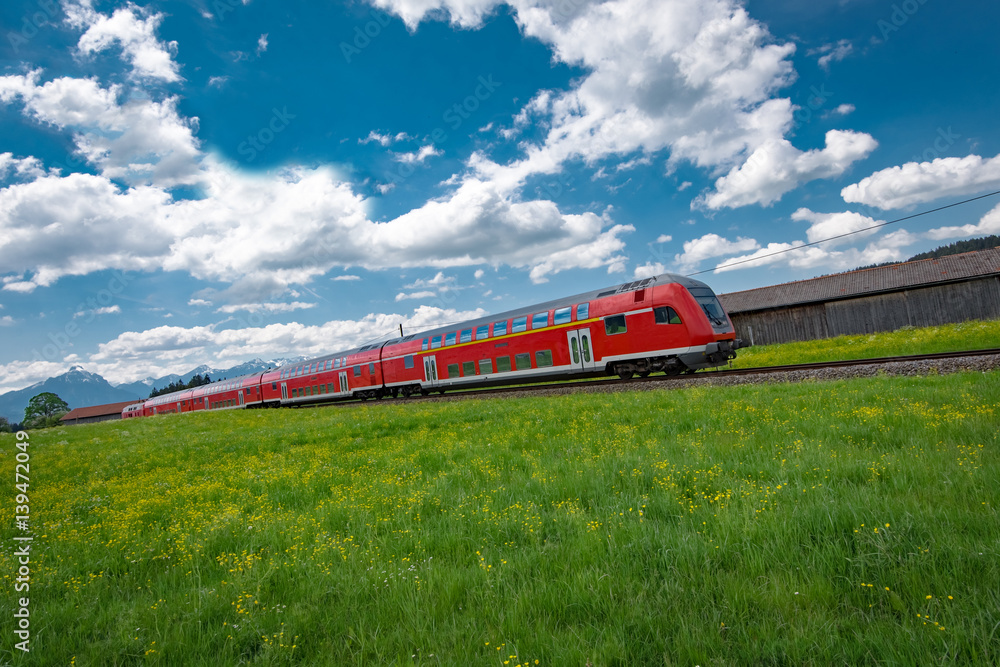 Rote Regionalbahn im Allgäu bei Oberstdorf - obrazy, fototapety, plakaty 