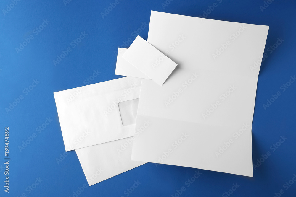 Blank brochure, envelope and card on blue background