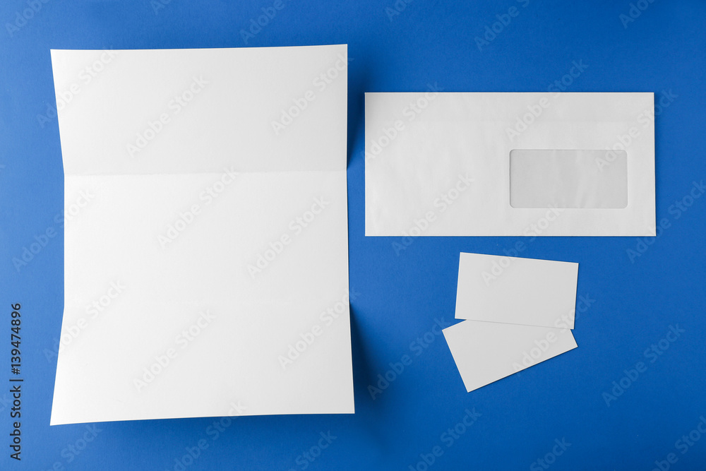 Blank brochure, envelope and card on blue background