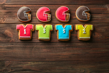 Poster - Tasty football cookies on wooden background