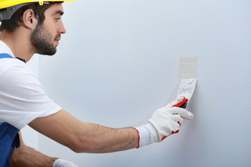 Wall Mural - Young worker making repair in room