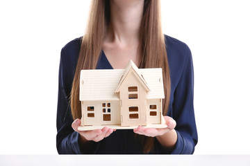 Sticker - Woman holding house model on white background