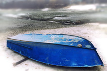 Old Upturned Boat Blue Lies On The Shore Of The Dried Lake .