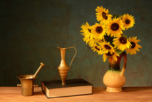 Sunflower In A Ceramic Vase And Books On The Table