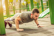 © zeljkomatic76 - Push-ups - fitness man training push up outside in summer.