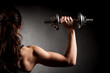 © Samo Trebizan - Atractive fit woman works out with dumbbells as a fitness conceptual over dark background
