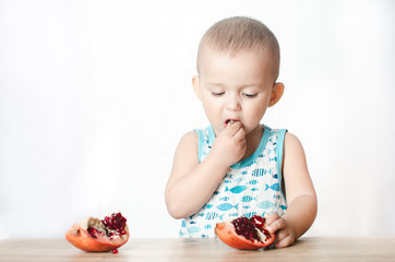 A child eating a pomegranate