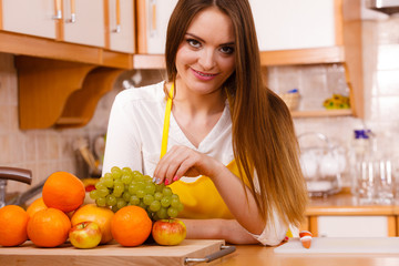 Smiling lady in kitchen.